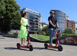 Young couple riding e-scooter